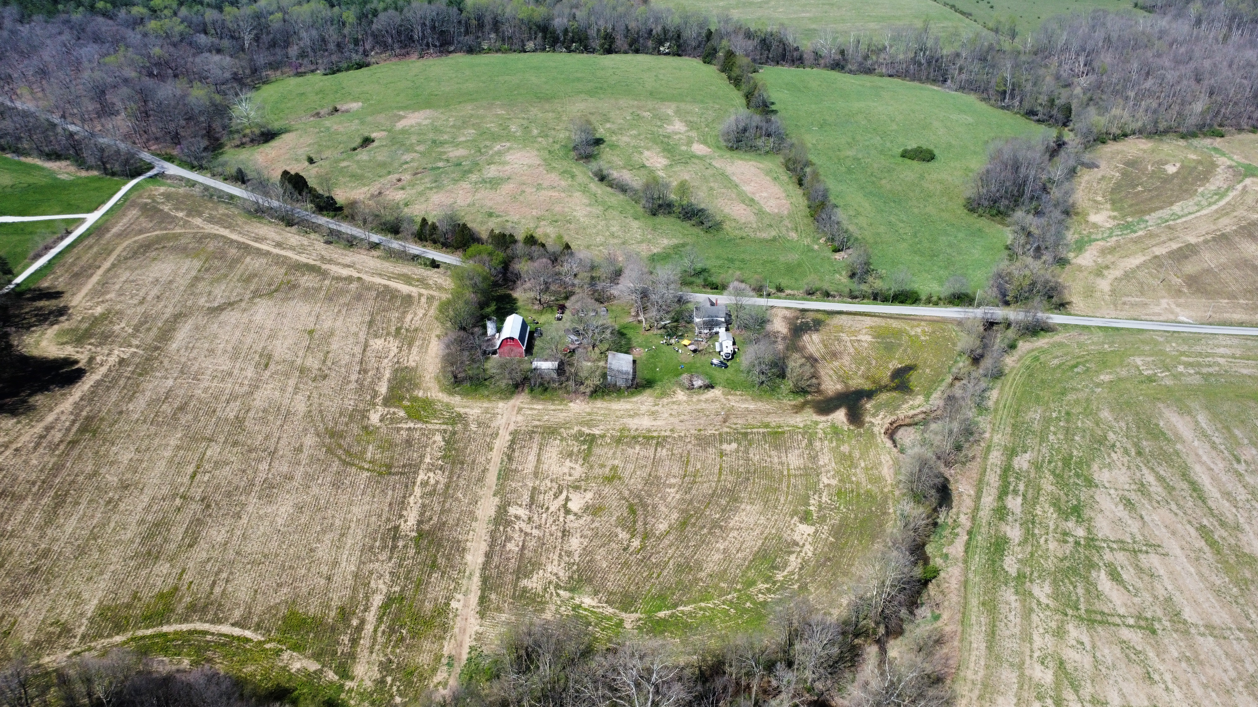Spring aerial view of the farm with red barn visible